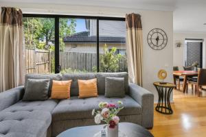 a living room with a couch and a table at New Comfort house near Box Hill in Nunawading