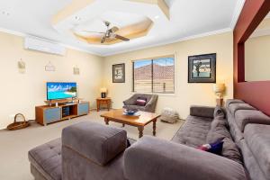 a living room with a couch and a tv at Home away from home at Corlette in Corlette