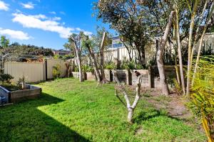 a garden with trees and a fence at Home away from home at Corlette in Corlette