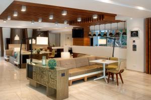 a living room with a couch and a table at Courtyard by Marriott Lima Miraflores in Lima
