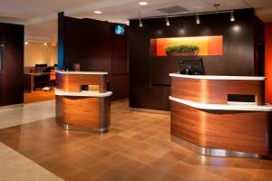 a lobby with two reception desks in a office at Courtyard by Marriott Fort Lauderdale Plantation in Plantation