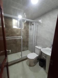 a bathroom with a shower and a toilet and a sink at Villa Graciela I in Paipa +24 photos