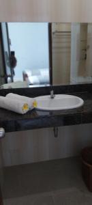 a white sink in a bathroom with a mirror at Kelana Guest House manage by LBV in Jimbaran
