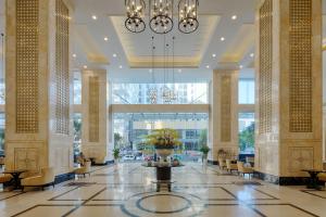 a lobby of a building with a vase of flowers at Vinpearl Beachfront Nha Trang in Nha Trang +130 photos