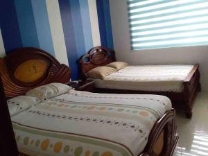 מיטה או מיטות בחדר ב-Deluxeguesthouse/vía Spondylus