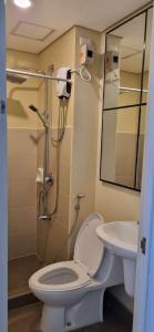 a bathroom with a toilet and a sink at 1 Bed 1 Bath Studio in Cagayan de Oro