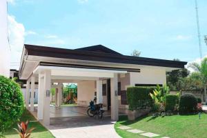 a small house with a motorcycle in front of it at Urban oasis40 in Talisay