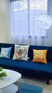 a blue couch with pillows on it in a living room at Urban oasis40 in Talisay