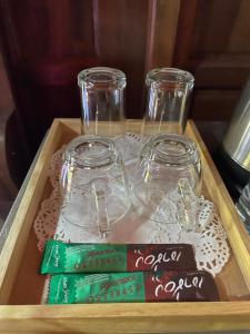 a wooden tray with three glass jars on a table at The Best Garden resort in Sichon