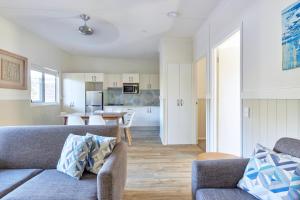 a living room with a couch and a table at NRMA Ocean Beach Holiday Resort in Umina