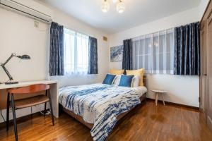 Postel nebo postele na pokoji v ubytování Nine Villa Kujukuri