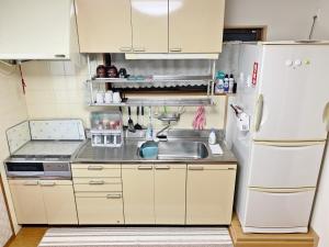 uma cozinha com um lavatório e um frigorífico em Reina Building 4F / Vacation STAY 61776 em Tokushima