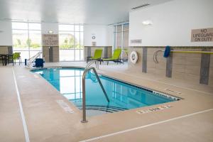 a large swimming pool in a building with a pool at SpringHill Suites Spokane Airport in Spokane