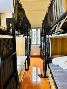 a group of bunk beds in a room with a hallway at A Páo Hostel Mộc Châu in Mộc Châu