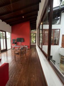 a living room with a bench and a red wall at R Degrees Villa - Nawala in Nawala