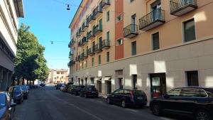 a street with cars parked on the side of a building at Marconi Rooms Alloggio Segreto in Verona