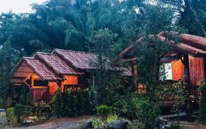 a house with red roofs in a forest at The Best Garden resort in Sichon