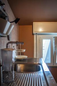 a kitchen with a sink and a counter top at APPARTAMENTO CAMPOVOLO in Reggio Emilia