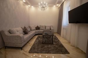 a living room with a couch and a table at Happy home in Tsaghkadzor
