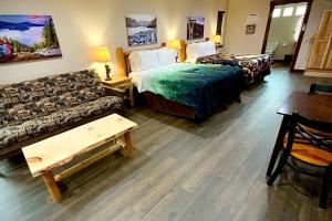 a hotel room with two beds and a couch at Bear Mountain - Suite 1 in Grants Pass