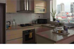 a kitchen with a sink and a stove top oven at Spectacular Sea View 3 Bedrooms Apartment in Colombo