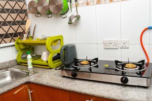 a kitchen counter with two burners on a stove at Ebrina One Bedroom in Port Harcourt