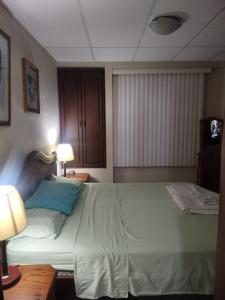 Un pat sau paturi într-o cameră la Villa Amoblada en Urbanización