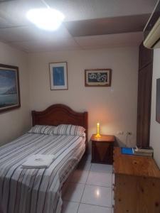 a bedroom with a bed and a candle on a table at Villa Amoblada en Urbanización in Machala