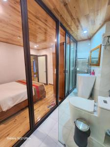 a bathroom with a bed and a toilet in a room at SaPa Retreat Condotel in Sa Pa