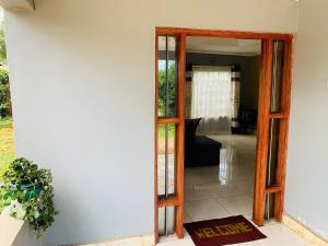 an open door to a room with a porch at Plush 3 Bedroom Apartment Home in Kitale
