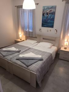 a bedroom with two beds with towels on them at Holidays in Paros in Aliki