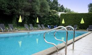 a swimming pool with lounge chairs and a swimming pooliterator at Hotel Baroko in Prague
