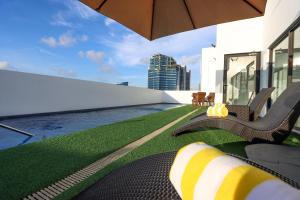 a balcony with chairs and a view of the city at Privato Makati in Manila