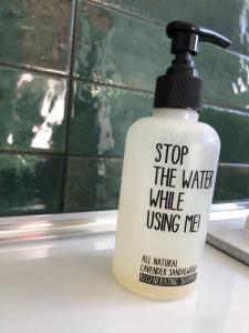 a bottle of water sitting on a bathroom sink at L'adret du bois in Sames