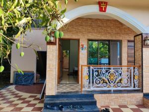 an entry to a house with a wrought iron gate at Resort - Toms Hideout in Mumbai