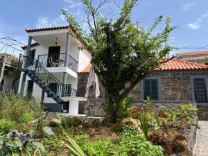 a house with a staircase in front of it at Casa do Avô in Ponta do Sol