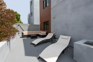 a patio with two chairs and a couch on a building at Regency Modern Apartments in Glendale