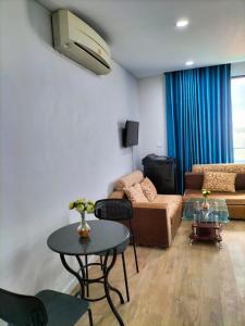 a living room with a couch and a table at Grand Condo 7 in Phnom Penh