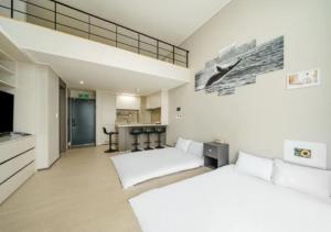 麗水的住宿－Coopstay Yeosu Hotel，一间大型客房,设有两张床和厨房
