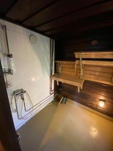 a bathroom with a shower and a bench in it at Jänkkärinne Cozy cabin Levi, Lapland in Kittilä