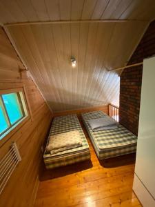 a room with two beds in a attic at Jänkkärinne Cozy cabin Levi, Lapland in Kittilä