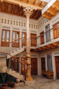 a building with stairs and a column in the middle at Hotel SHOHRUD in Bukhara