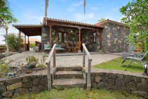 a stone house with a staircase leading to a patio at Casa Rural Arecida in Tijarafe