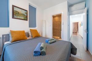 1 dormitorio con 1 cama grande con almohadas azules en Blue Diamond Beach Villas, en Pafos