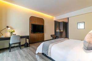 Postel nebo postele na pokoji v ubytování Empathy Hotel - Guangzhou East Railway Station Tianhe Sports Center