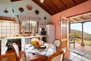 a kitchen with a table with a bowl of fruit on it at La Roquina in Tijarafe