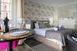 sypialnia z łóżkiem i stołem z płytami w obiekcie La Suite de la Catedral by Unique Rooms w mieście Burgos