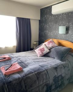 a bedroom with a large bed with pillows on it at Home away from home air b and b in Whangarei