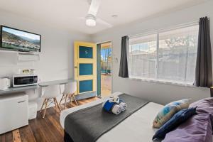 a bedroom with a bed and a desk at Pacific Motor Inn in Evans Head