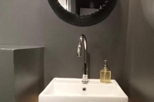 a bathroom sink with a mirror and a soap dispenser at Maison à colombages près de Deauville, Trouville in Formentin +20 photos
